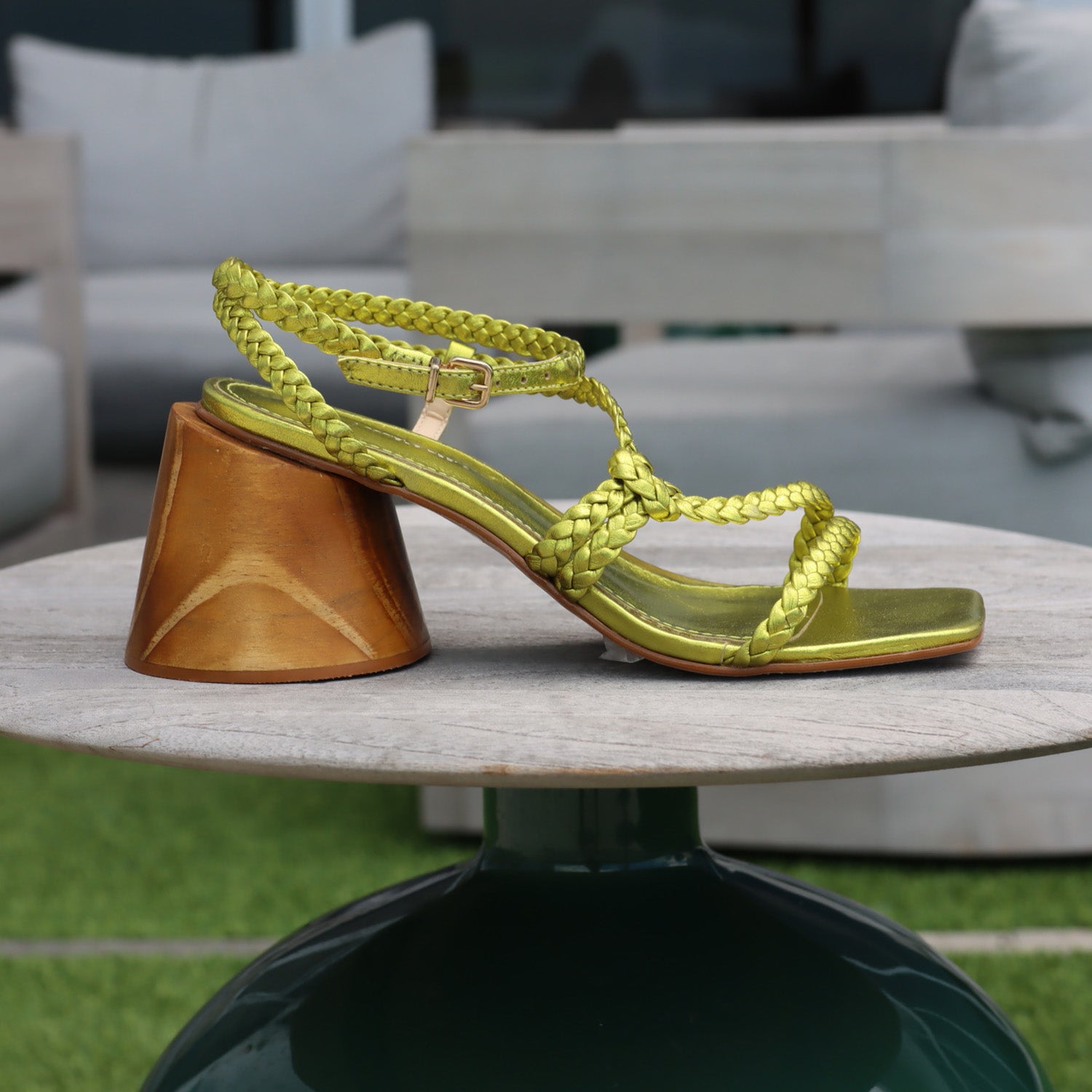 Felicity Metallic green sandal with braided straps and wooden sole.
- Juliana Heels